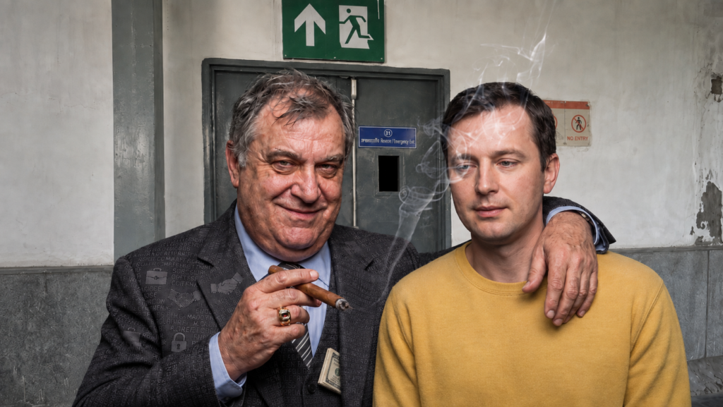 Younger man in yellow beside an older salesman near a locked exit door