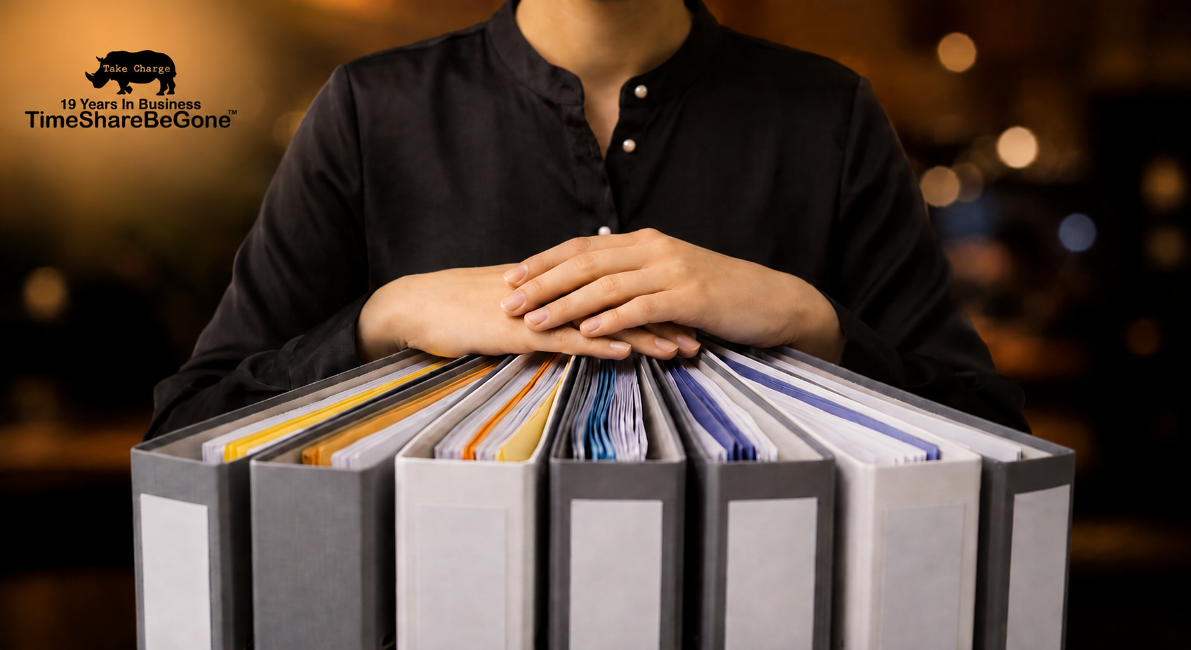 Woman organizing timeshare contract files with TimeShareBeGone branding