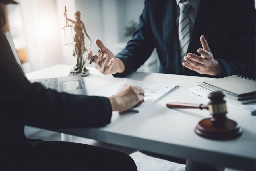Timeshare attorney in California providing legal consultation, reviewing contracts, and discussing timeshare cancellation options with a client in an office setting