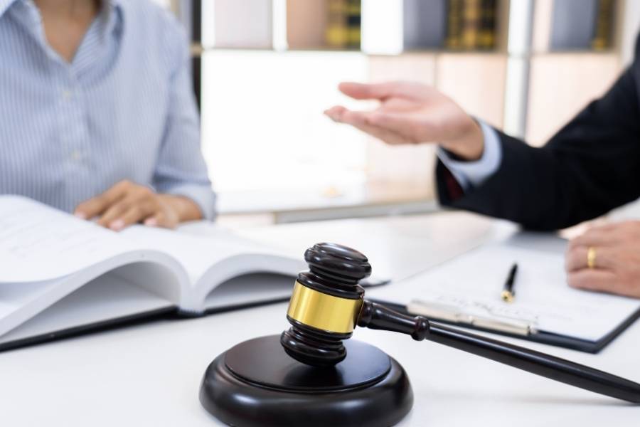 A legal or consultation setting, featuring a lawyer’s desk, gavel, or contract signing.