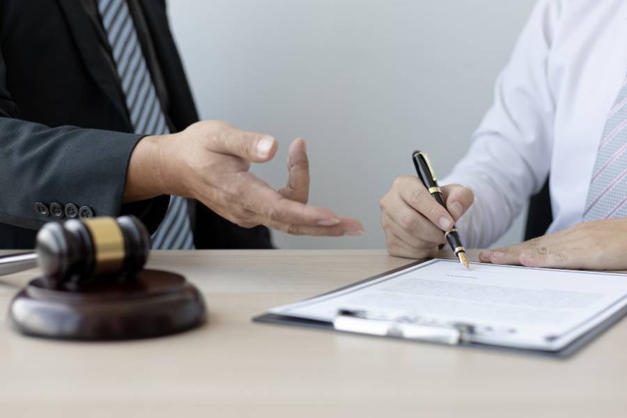 Lawyer advising client on signing legal documents for timeshare cancellation in Washington.