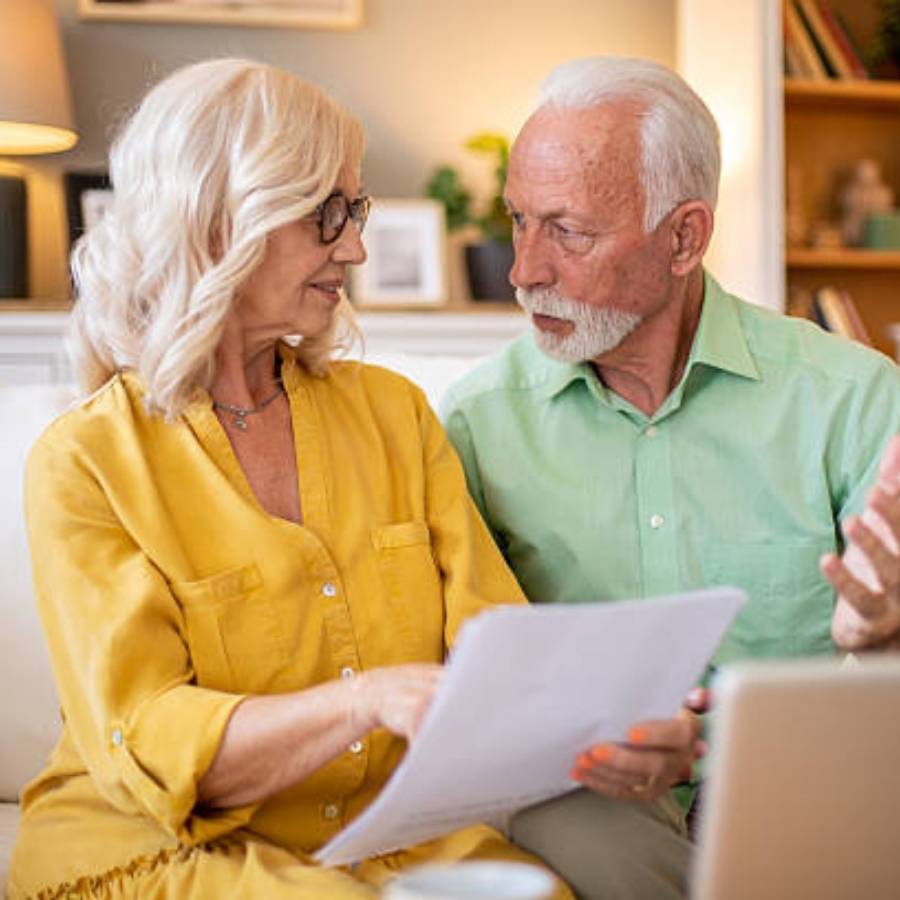Senior couple discussing timeshare cancellation paperwork at home