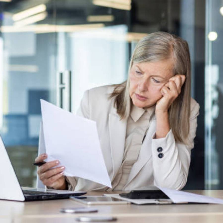 Businesswoman reviewing timeshare cancellation documents at office desk