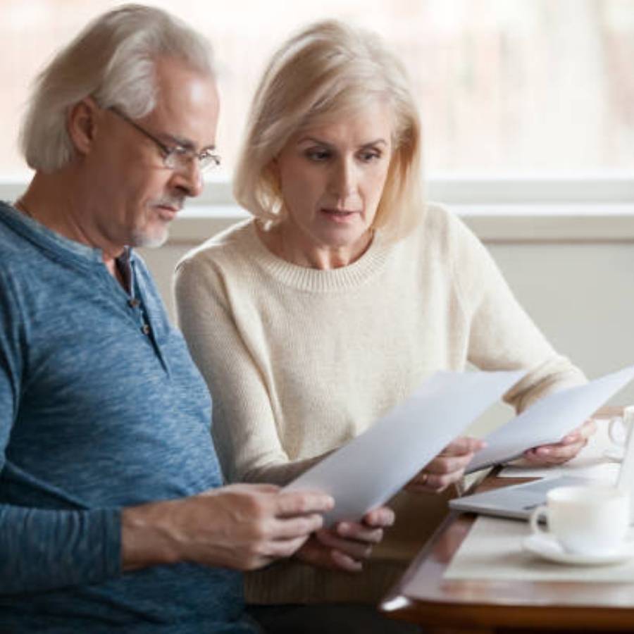 Senior couple reviewing timeshare cancellation documents together at home