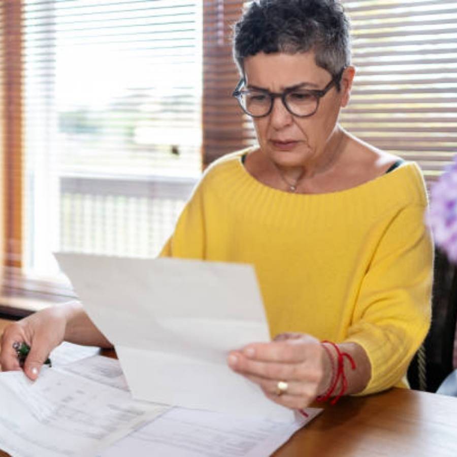 Concerned woman reviewing timeshare cancellation documents at home