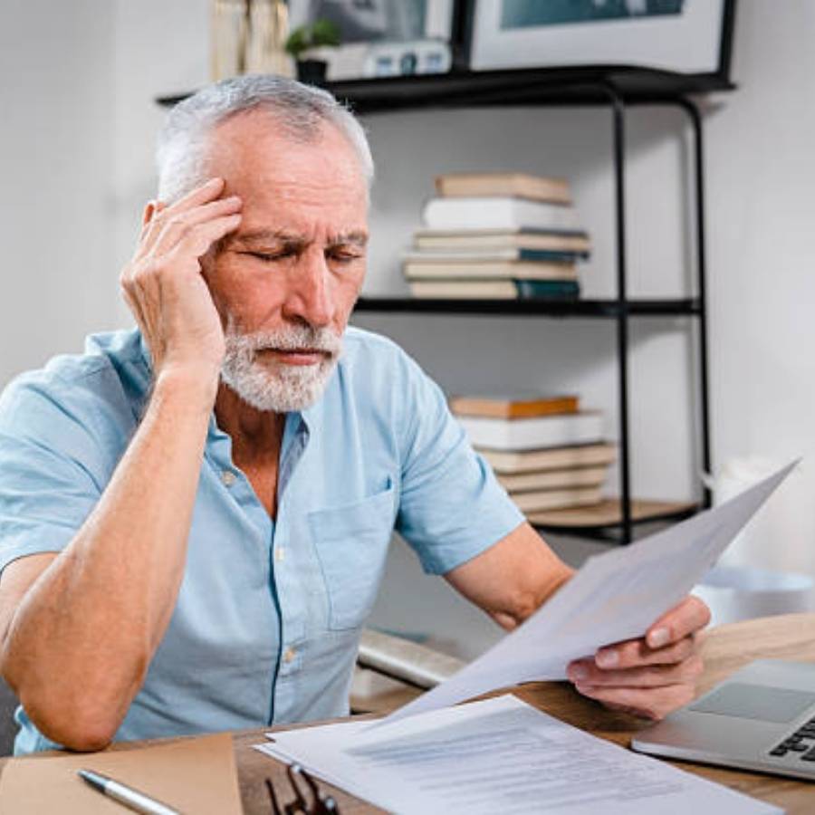 looking over papers, appearing thoughtful or concerned.