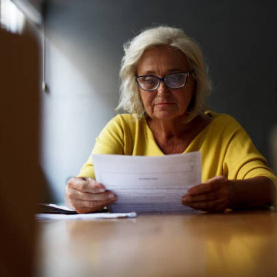 Senior woman reviewing paperwork for timeshare cancellation in Washington.