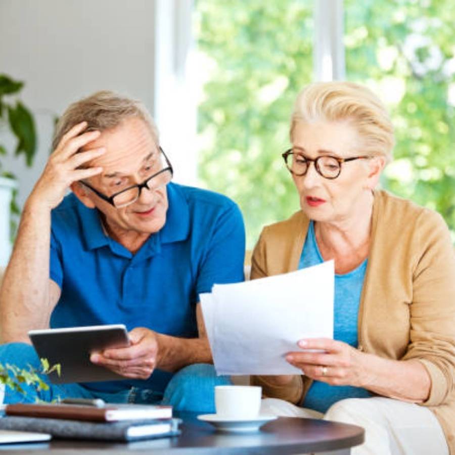 Senior couple reviewing documents and discussing timeshare cancellation in Wyoming.