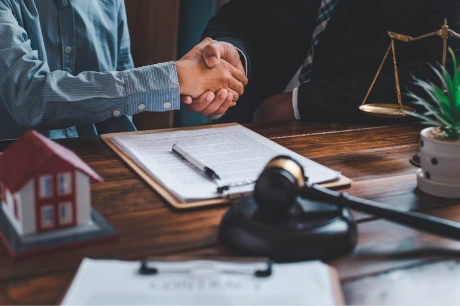 Client shaking hands with lawyer after timeshare cancellation agreement in Durham, North Carolina
