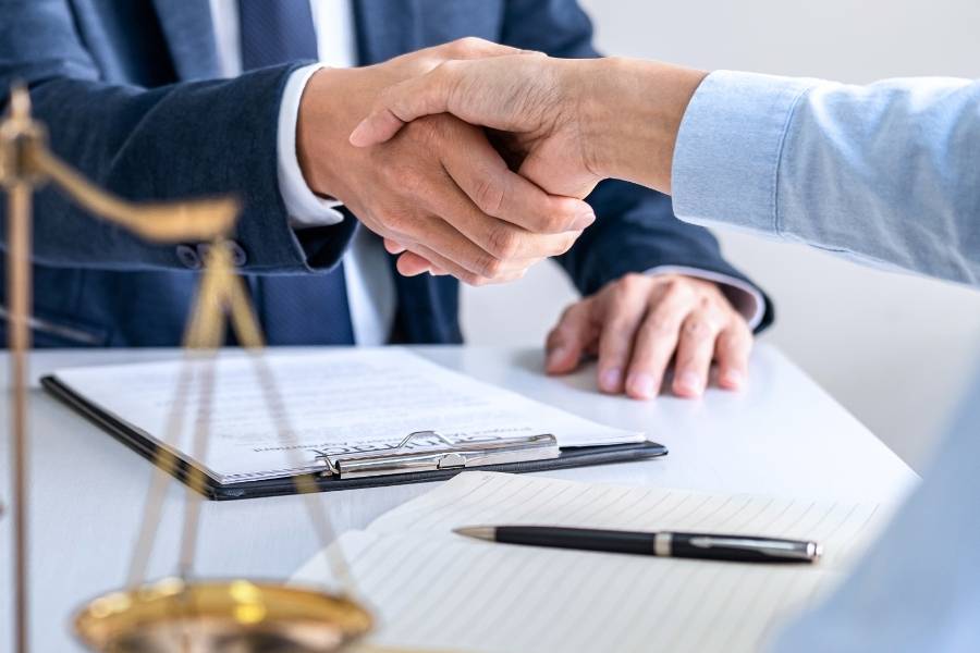 Client and lawyer shaking hands after successful timeshare cancellation in Greensboro, North Carolina