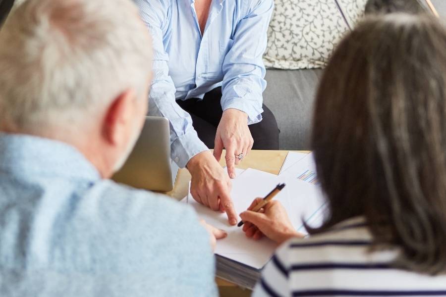 Couple reviewing documents with a consultant, discussing timeshare cancellation options in Jacksonville, Florida.