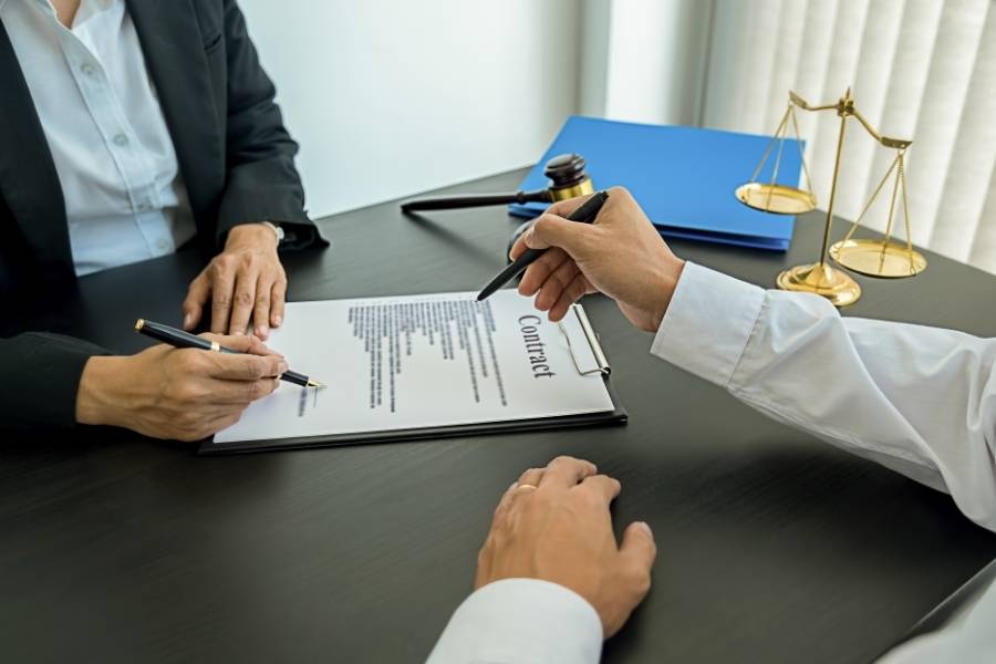 Attorney reviewing timeshare cancellation contract with client in Macon, Georgia