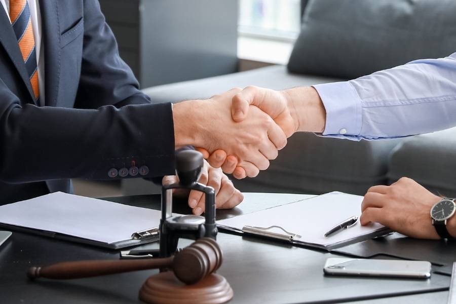 Lawyer and client shaking hands after successful timeshare cancellation agreement in St. Petersburg, Florida.