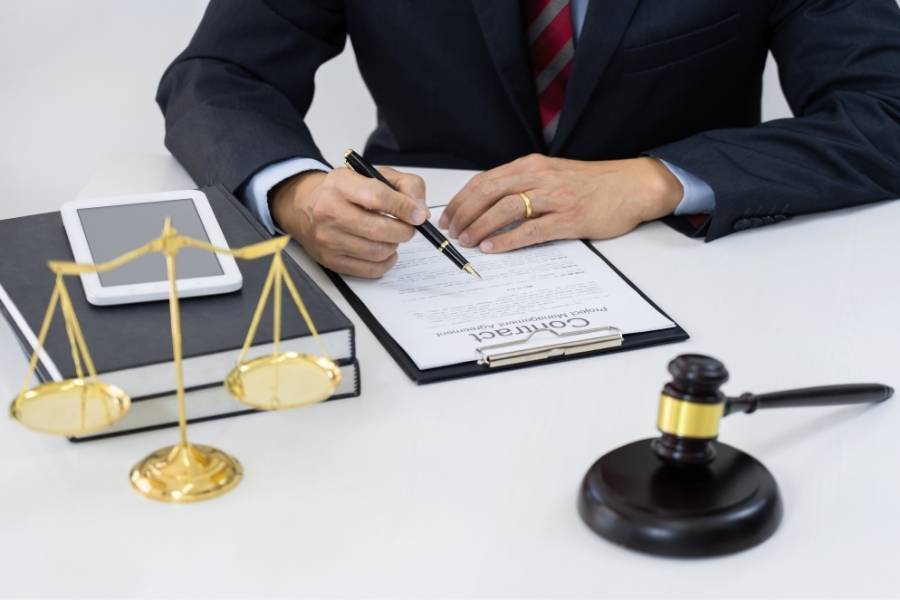 Lawyer signing legal contract for timeshare cancellation in Wilmington, North Carolina