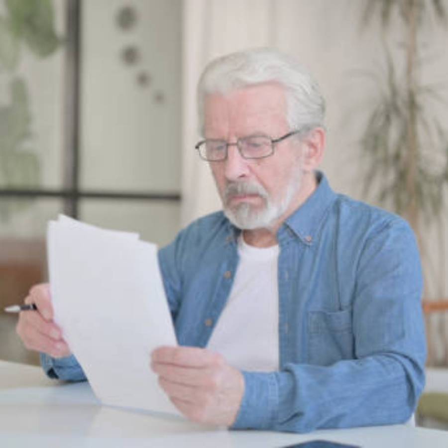 Senior man reviewing timeshare cancellation paperwork in Charlotte, North Carolina