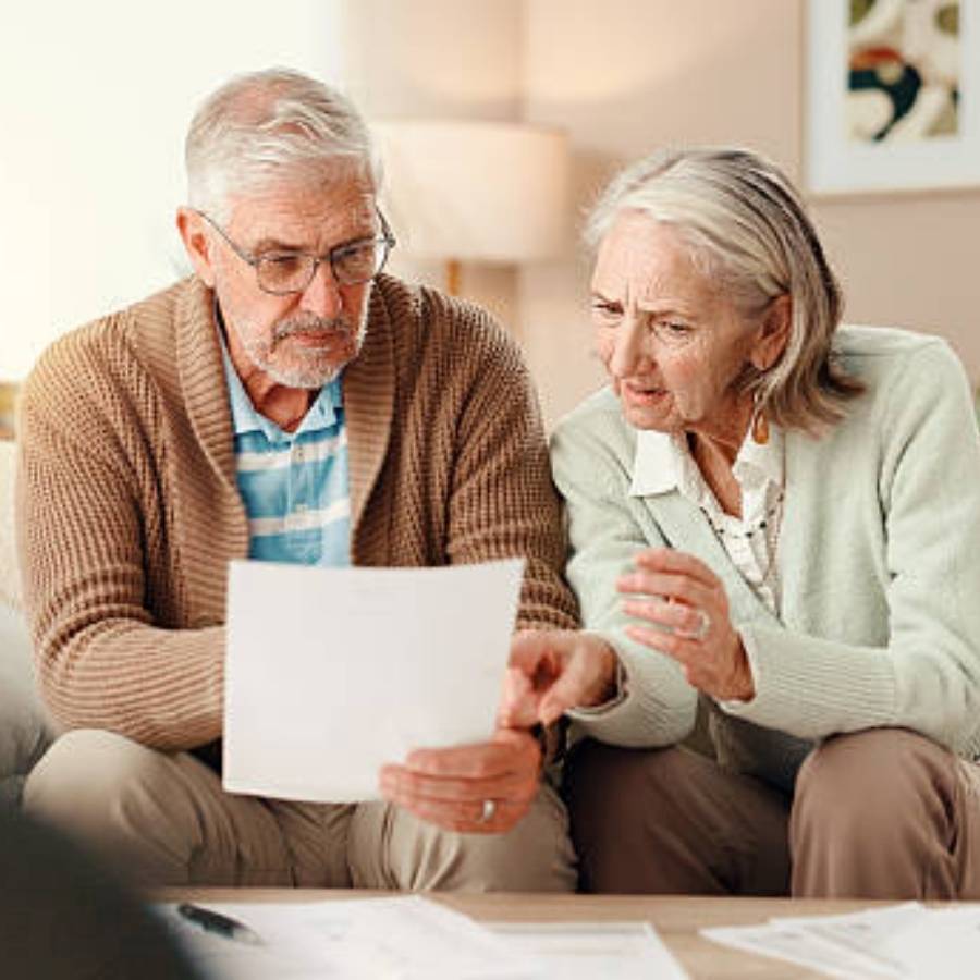 Senior couple reviewing timeshare cancellation documents together at home in St. Petersburg, Florida.
