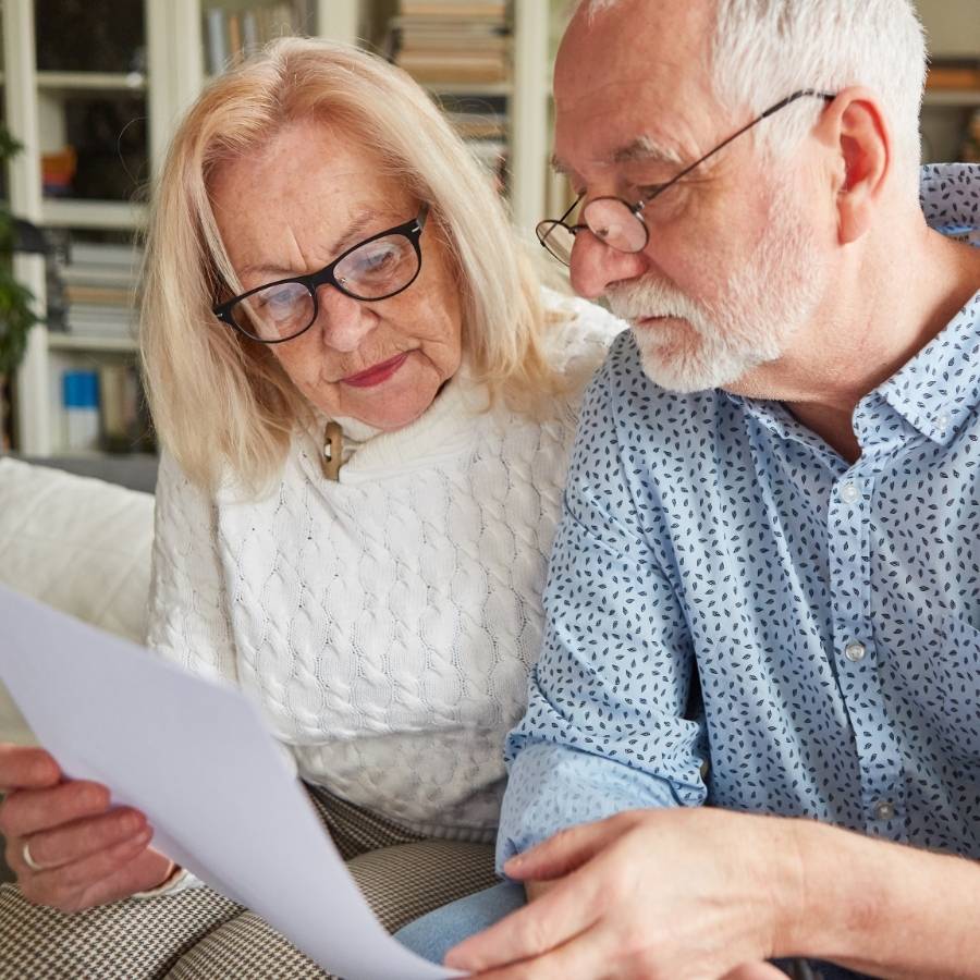 Senior couple reviewing timeshare cancellation documents at home in Tampa, Florida