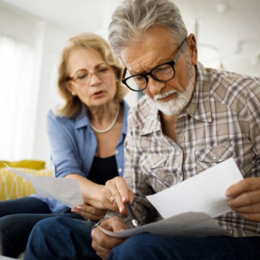 stressed senior couple reviewing a timeshare cancellation contract