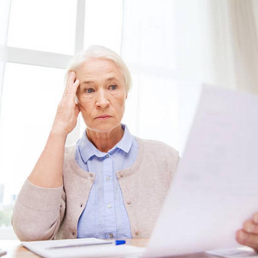 stressed senior woman reviewing timeshare contract