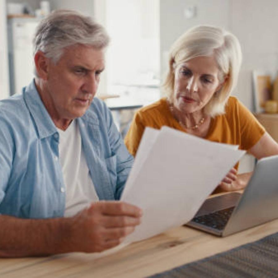 Senior couple reviewing timeshare cancellaton contract