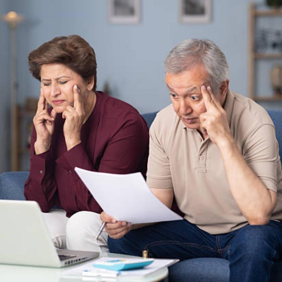 stressed senior couple reviewing a timeshare cancellation contract