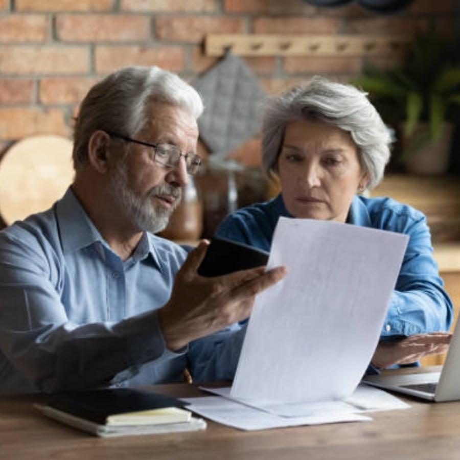 old couple reading timeshare cancellation contract