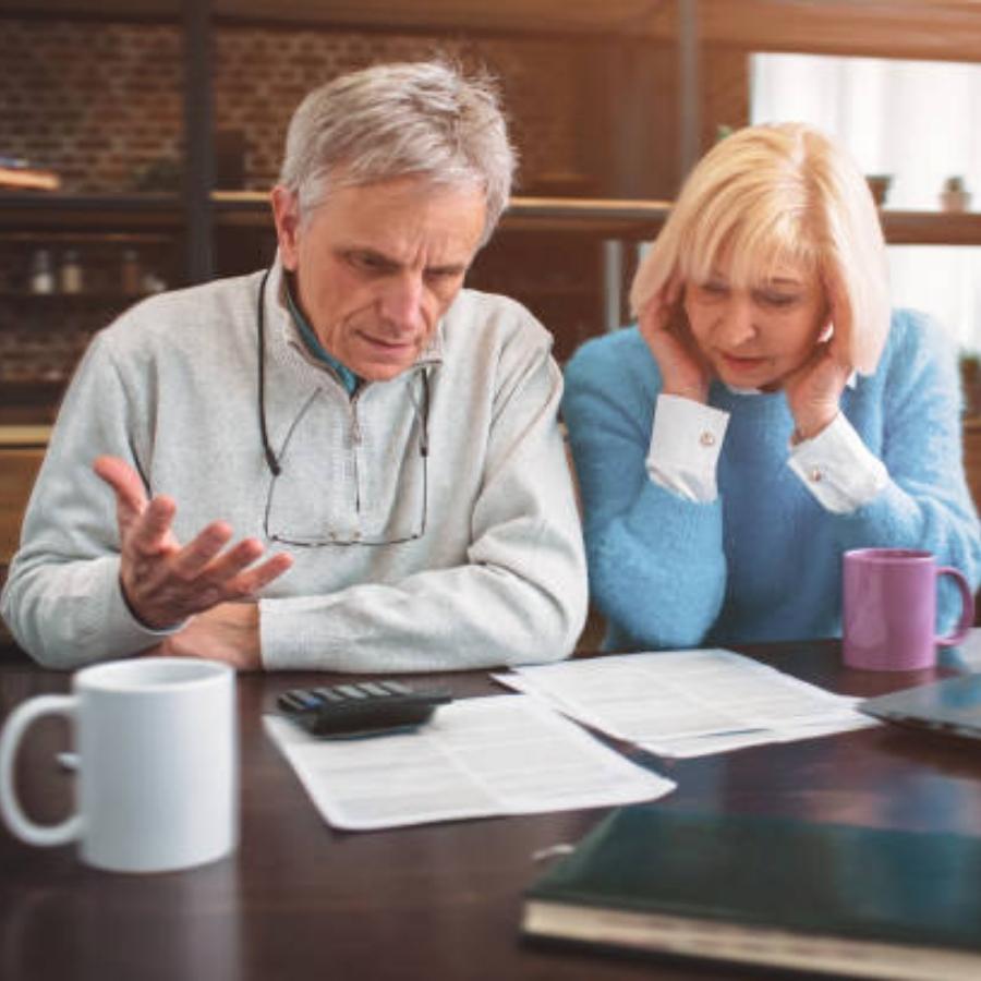 senior couple reviewing a timeshare cancellation contract