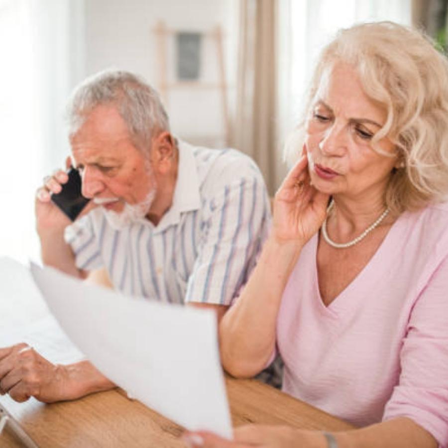 stressed senior couple reviewing a timeshare cancellation