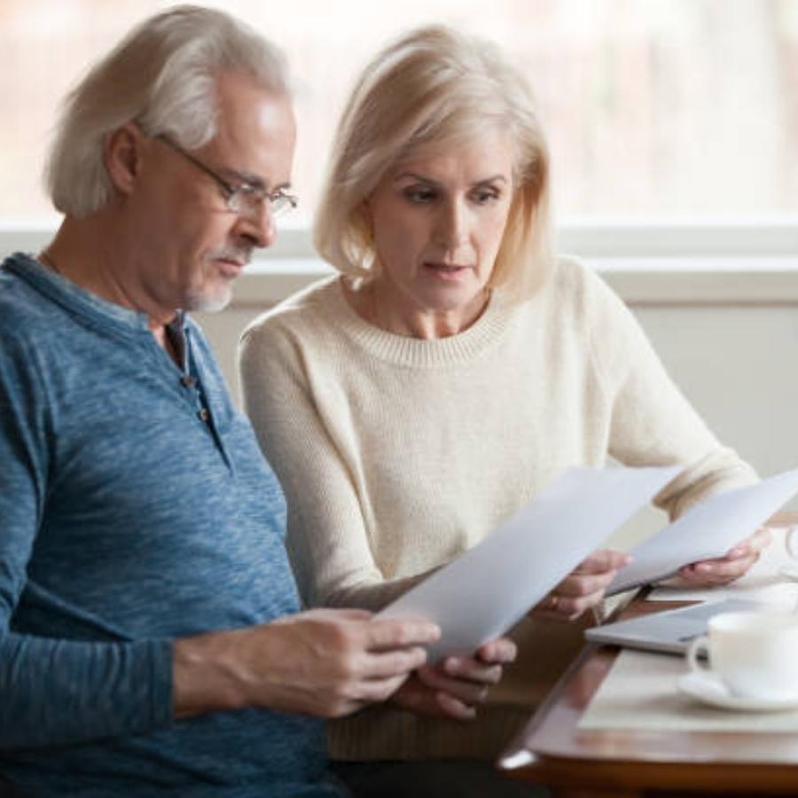 senior couple reviewing timeshare cancellation contract