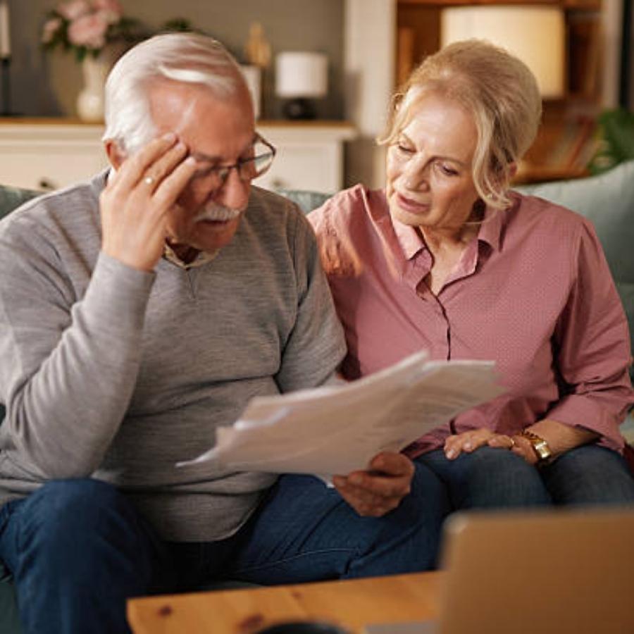 stressed senior couple reviewing a timeshare cancellation contract