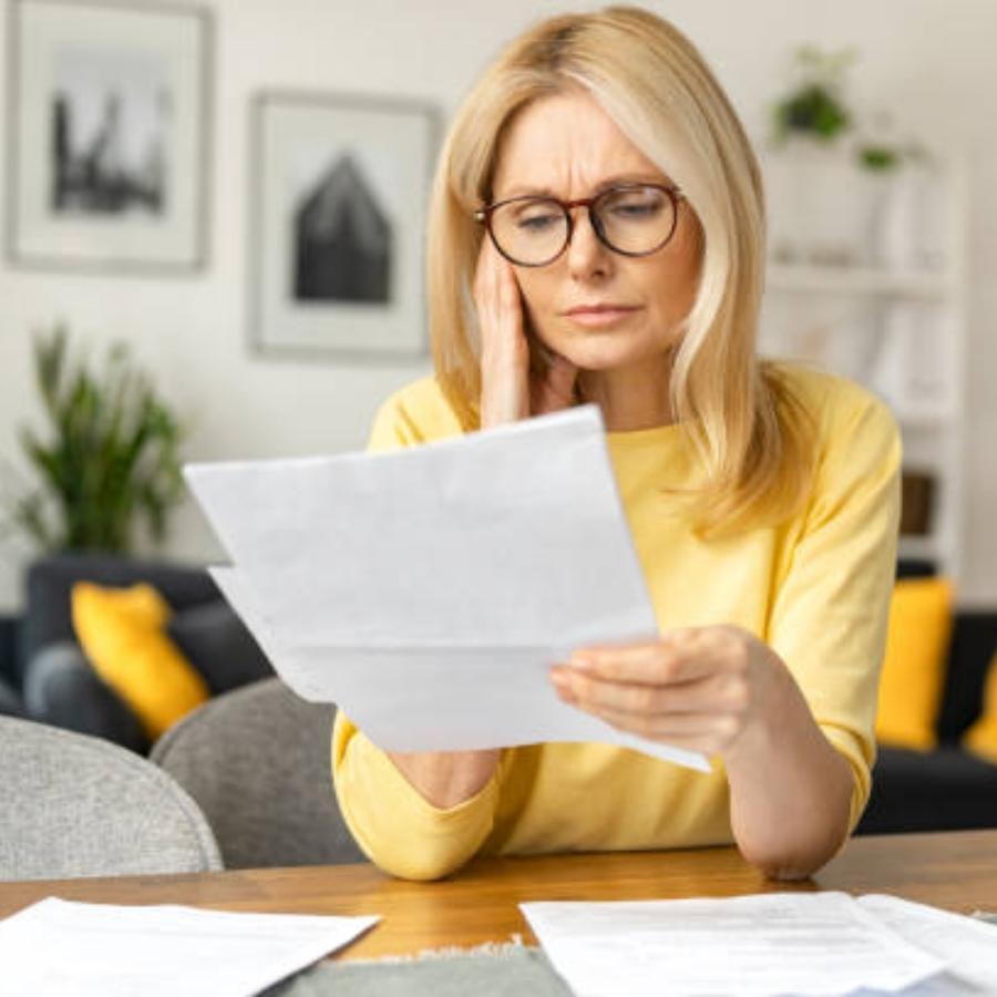 stressed senior woman reviewing a timeshare contract