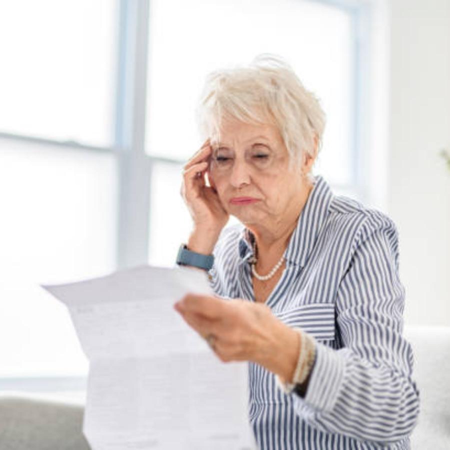 stressed senior woman reviewing a timeshare contract