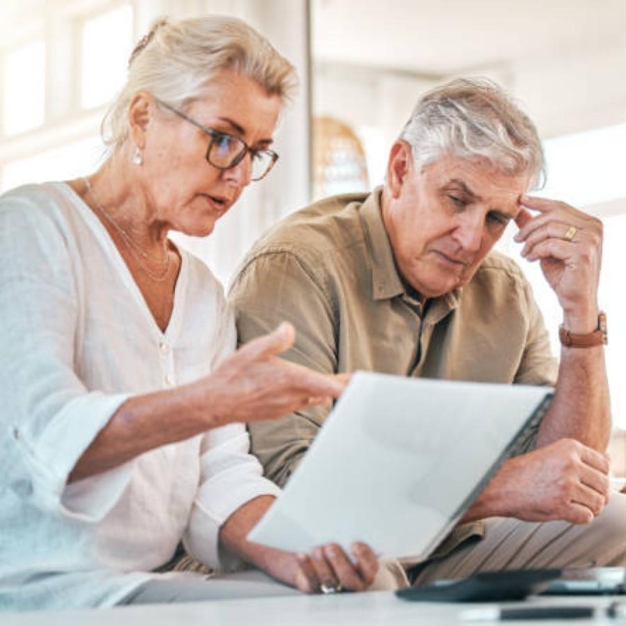 stressed couple reading timeshare cancellation contract