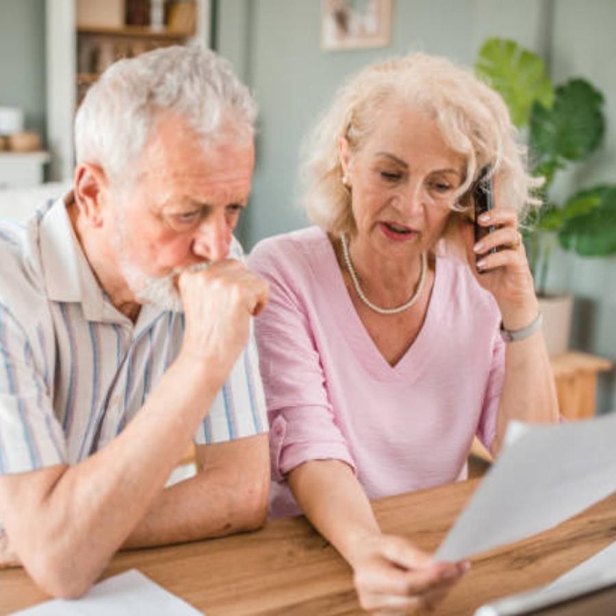 stressed senior couple reading timeshare cancellation contract
