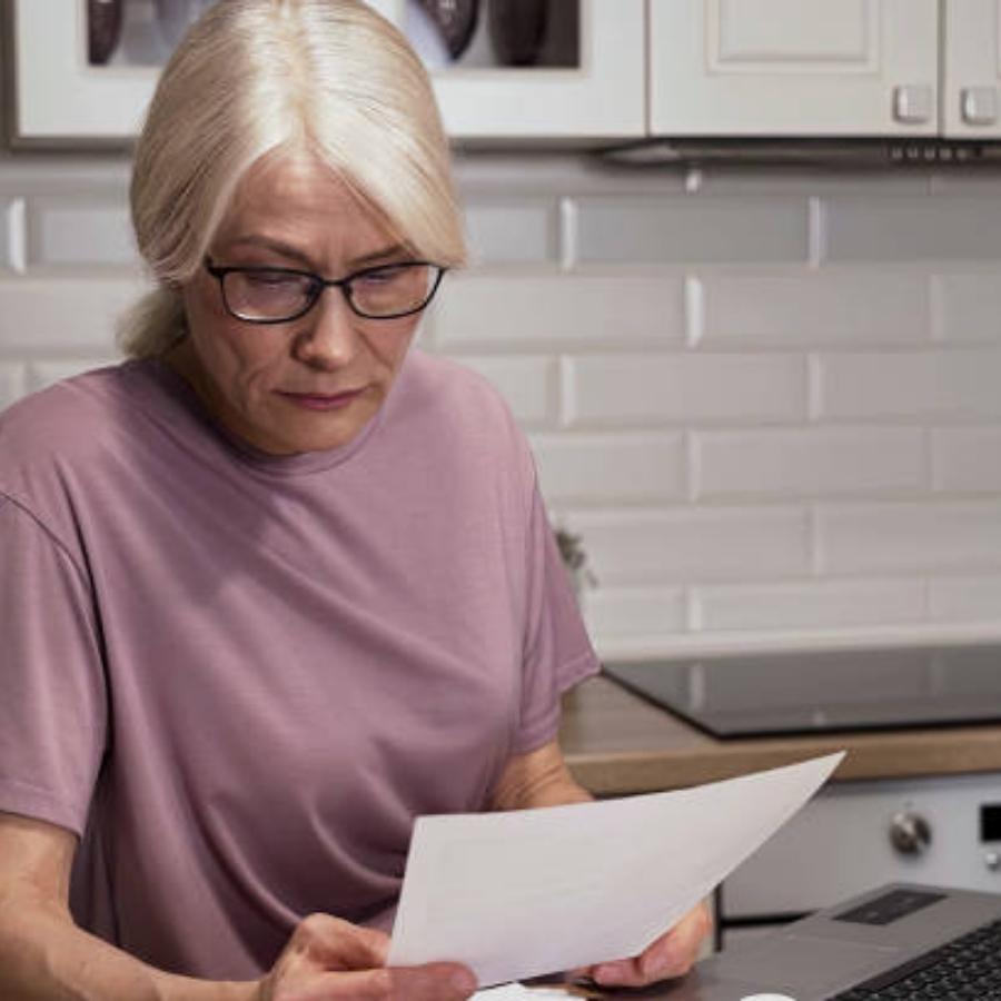 stressed senior woman reviewing a timeshare contract