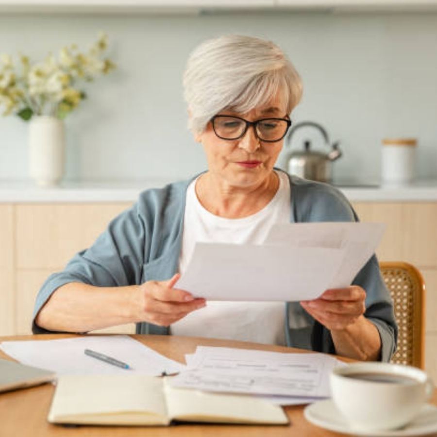 senior woman reviewing timeshare contract documents