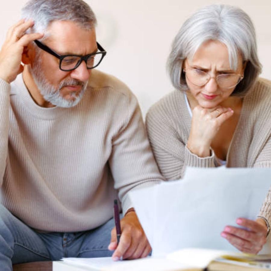 stressed senior couple reading timeshare cancellation