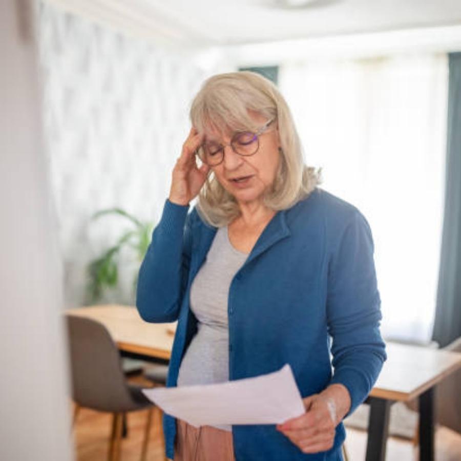 stressed senior woman reviewing a timeshare contract