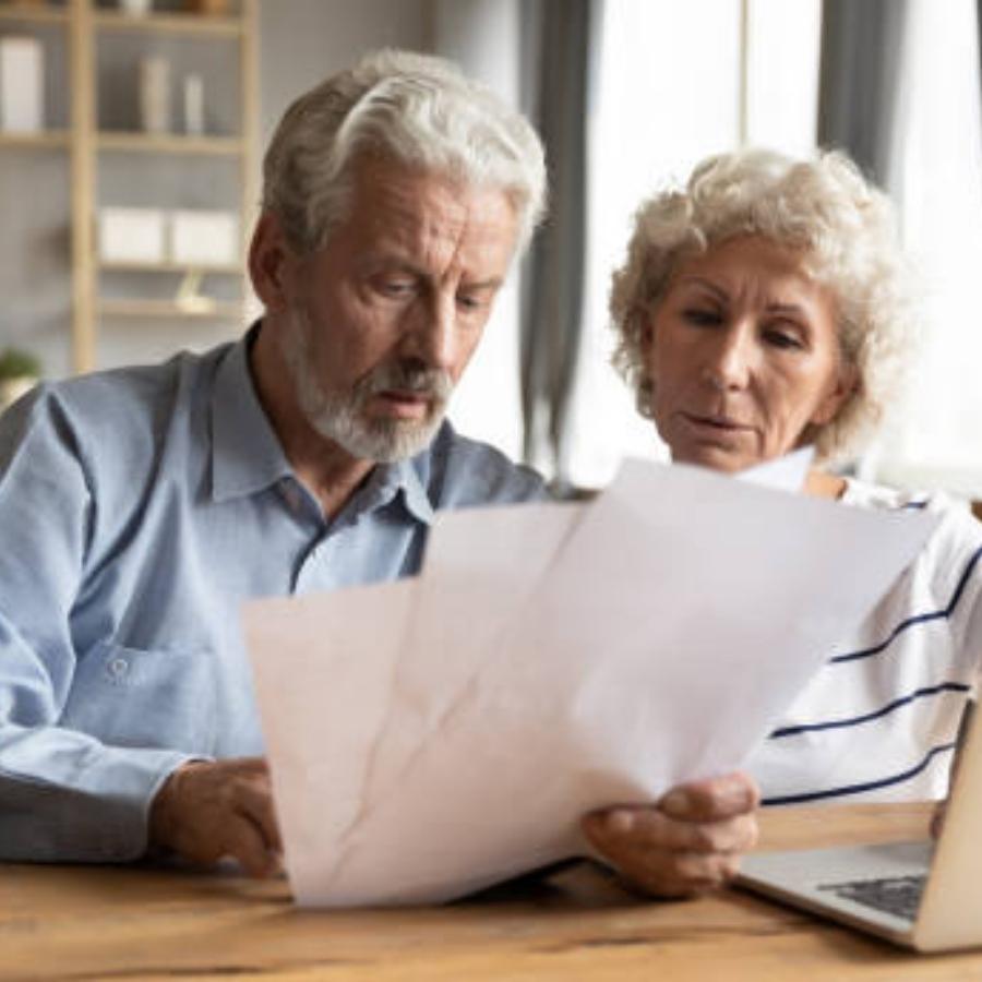 senior couple reviewing a timeshare cancellation contract
