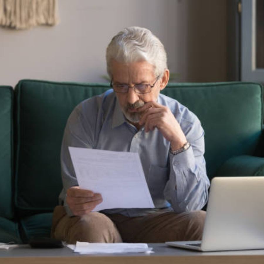 senior man reviewing timeshare contract