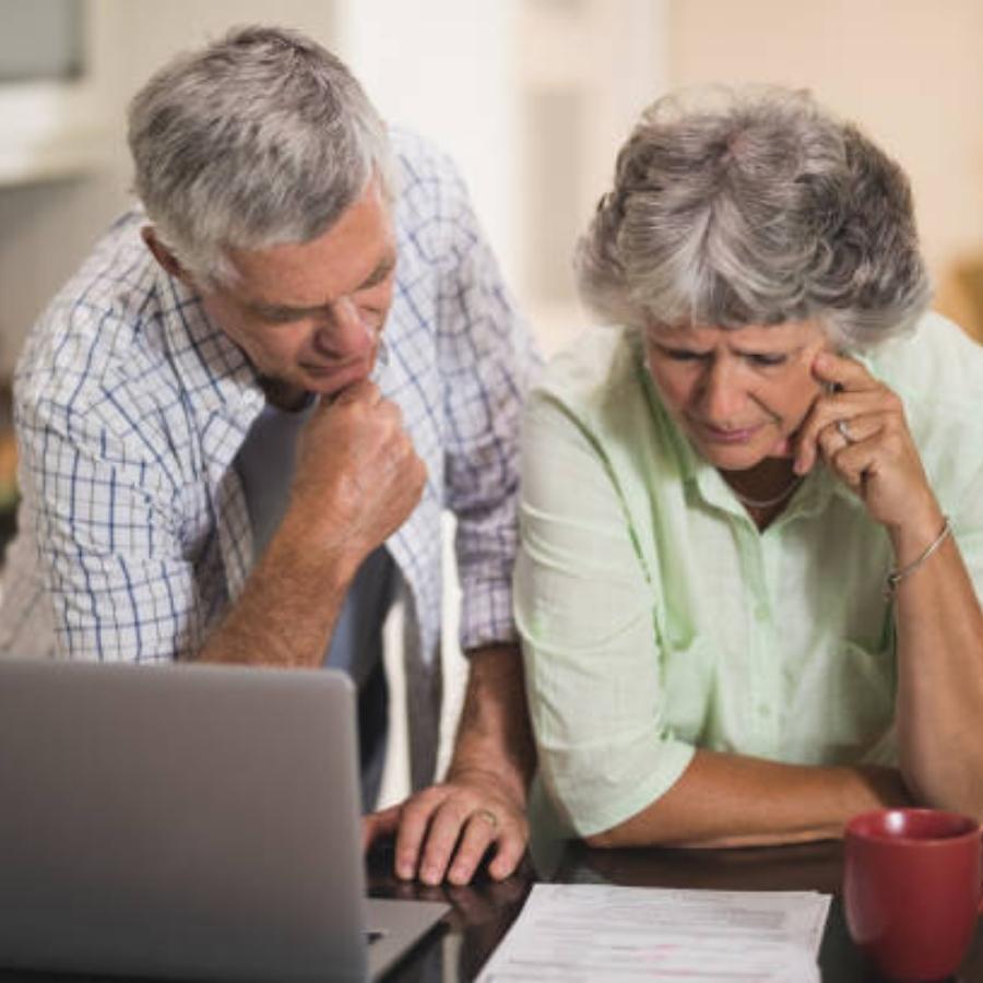 stressed senior couple reading timeshare contract