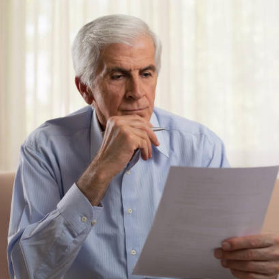 senior man reviewing a timeshare contract