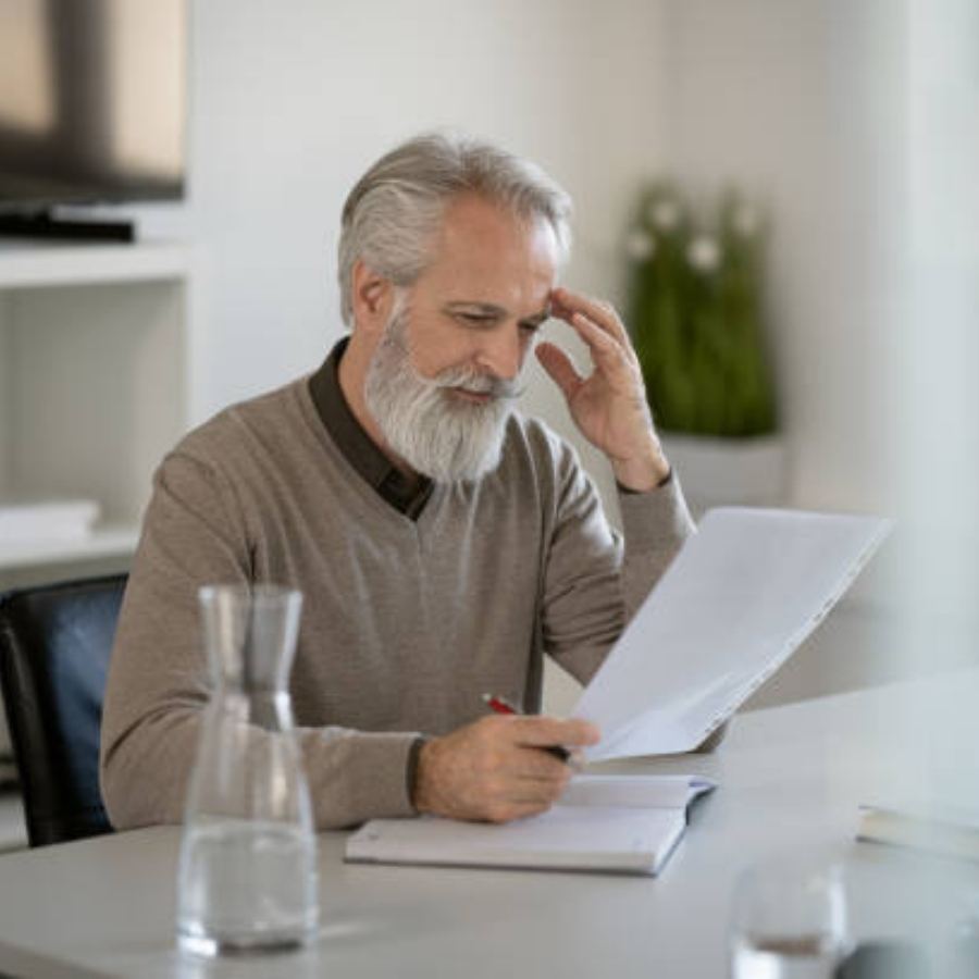 senior man reviewing timeshare contract