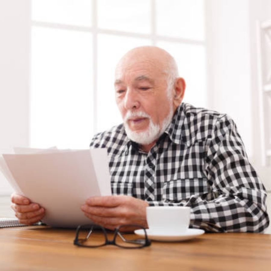 senior man reviewing timeshare contract