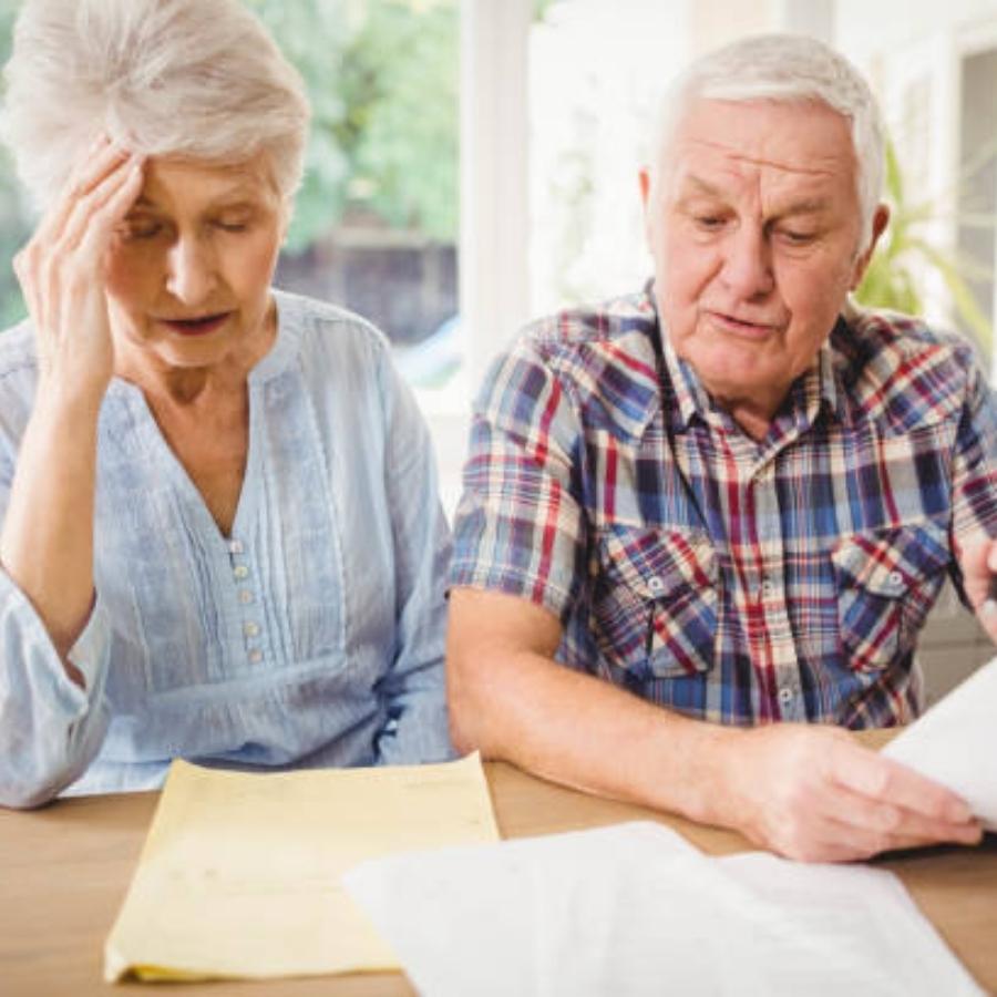 stressed senior couple reviewing timeshare cancellation contract