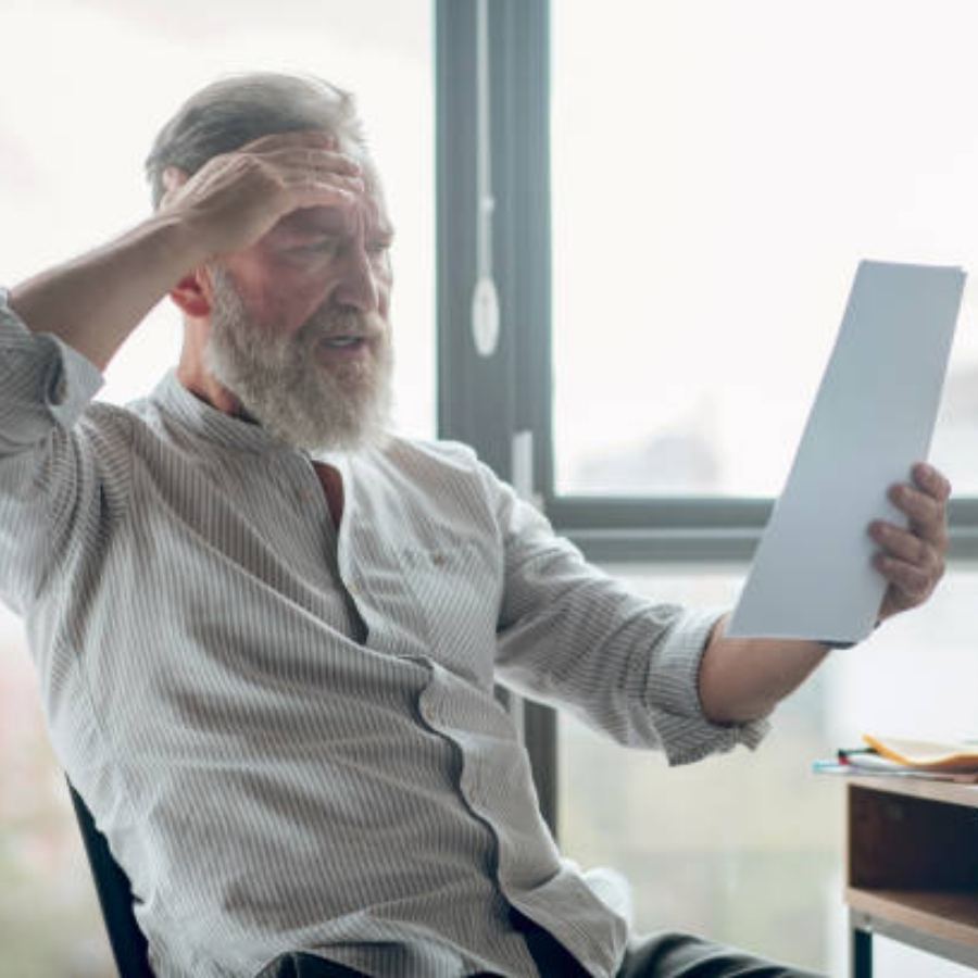 senior man reviewing timeshare contract