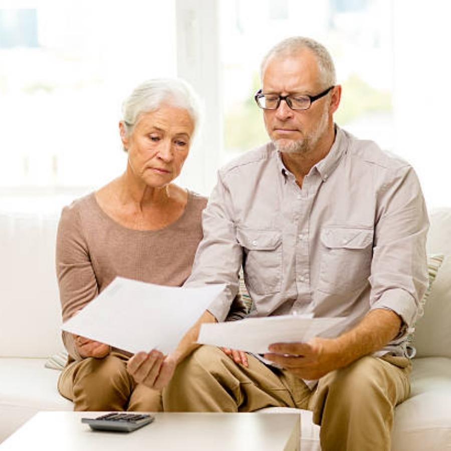 stressed senior couple reviewing a  timeshare cancellation contract