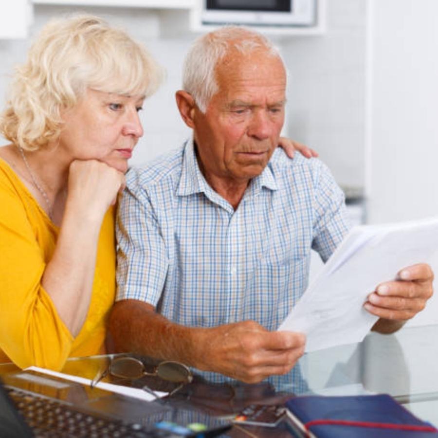 stressed senior couple reviewing timeshare cancellation contract