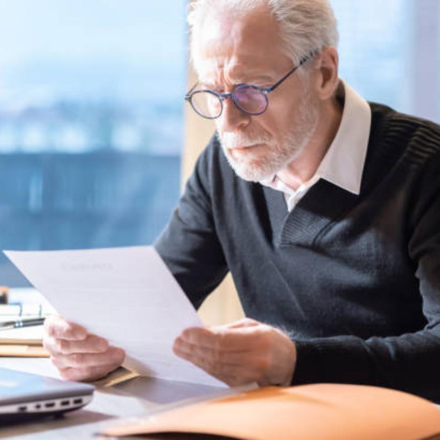 senior man reviewing a timeshare contract