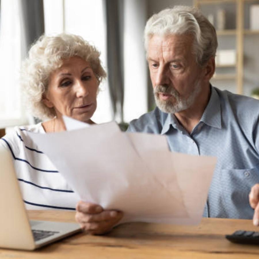 stressed senior couple reviewing a timeshare cancellation contract